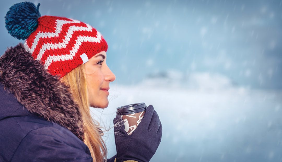 Woman in Coat Holding Hot Beverage